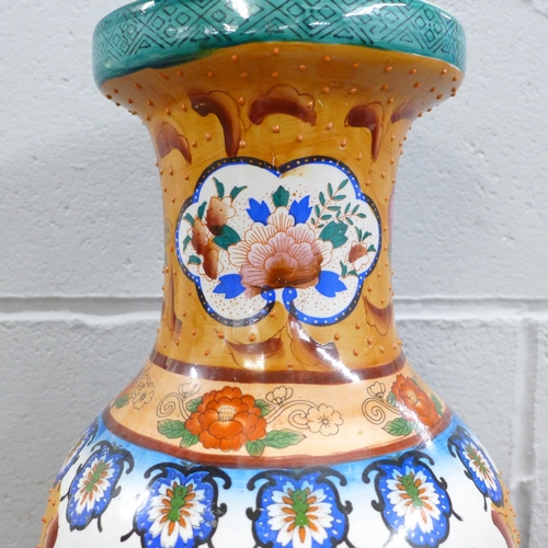 794 - A large Oriental temple vase, 60cm