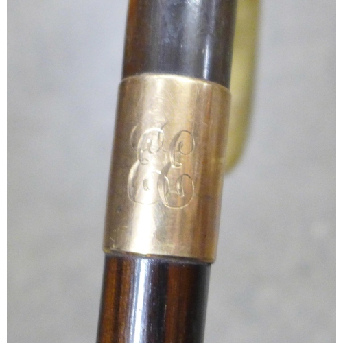 796 - Two walking sticks with horn handles and 9ct gold mounts - both monogrammed and one engraved 1933