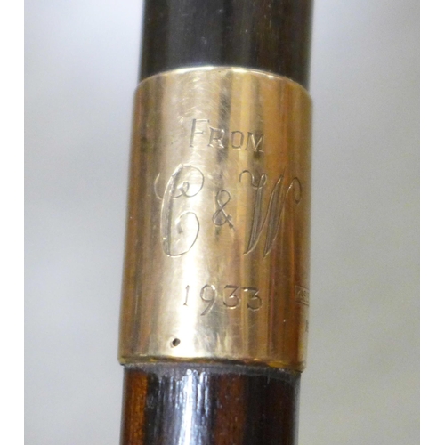 796 - Two walking sticks with horn handles and 9ct gold mounts - both monogrammed and one engraved 1933