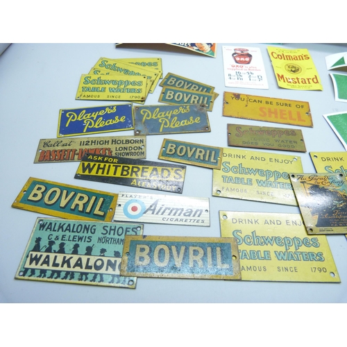 803 - A collection of Bassett-Lowke mid-20th Century model rail tin-plate advertising signs and some paper... 