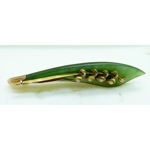 964 - A jade brooch set with seed pearls in a yellow metal mount (tests as 9ct gold, base metal pin) toget... 