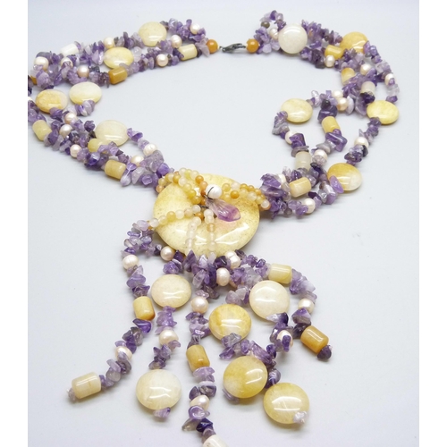 973 - A string of amethyst, pearl and hardstone beads with silver mount