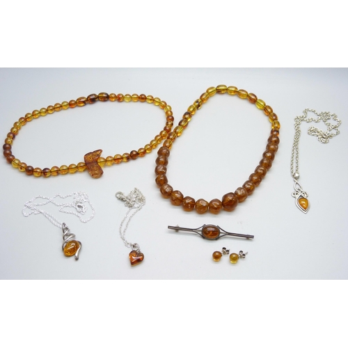 976 - A collection of silver and amber jewellery;- three necklaces, a bead necklace, a brooch and a pair o... 