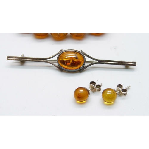 976 - A collection of silver and amber jewellery;- three necklaces, a bead necklace, a brooch and a pair o... 