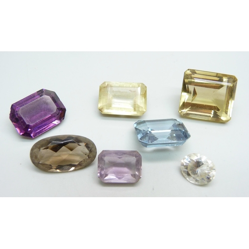 977 - A collection of seven unmounted gemstones including citrine