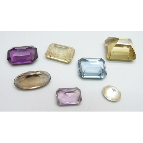 977 - A collection of seven unmounted gemstones including citrine