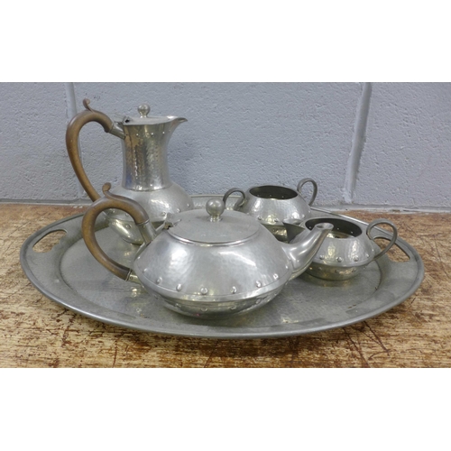 989 - A four piece pewter tea service and a tray