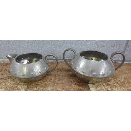 989 - A four piece pewter tea service and a tray