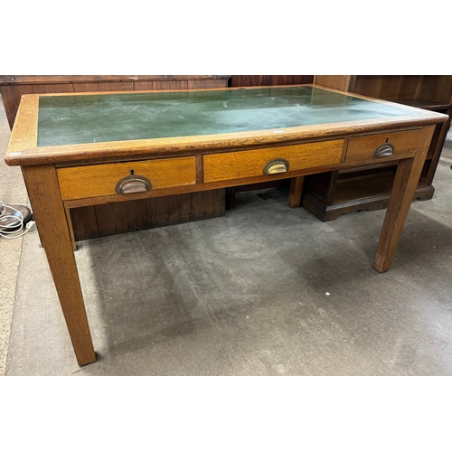 173 - An early 20th Century oak three drawer library table