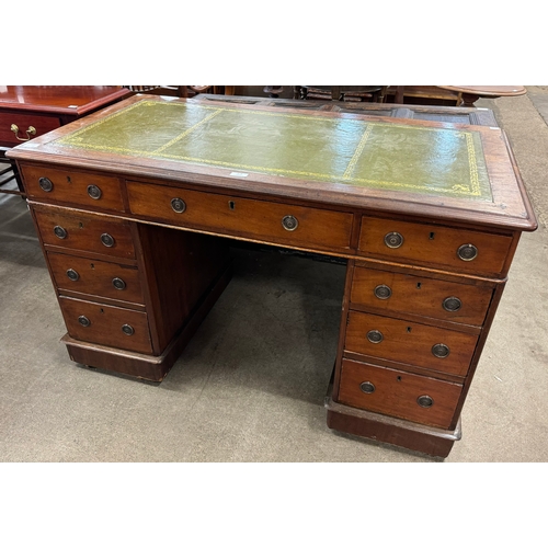 174 - A Victorian mahogany and green leather topped pedestal desk