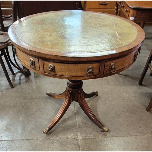 95 - A Regency style mahogany and green leather topped drum shaped library table