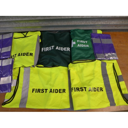 2384 - A bag of approx 20 First Aid hi-visibility vests in assorted sizes and styles