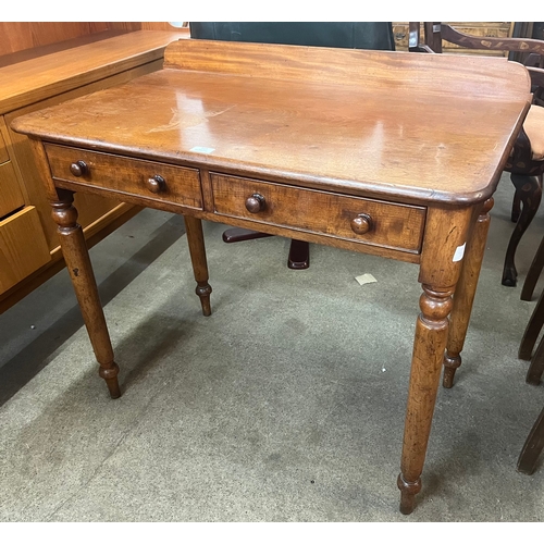 121 - A Victorian mahogany two drawer writing table