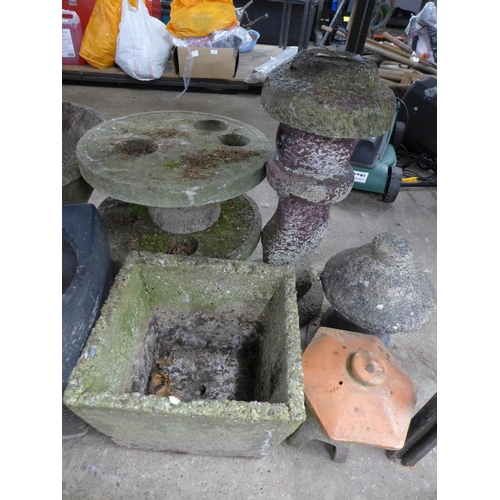 2418 - A large collection of assorted garden decorative items and planters including some stone