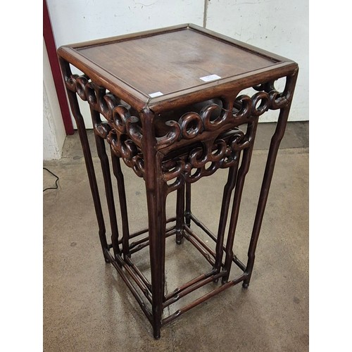 105 - A Chinese carved hardwood nest of tables