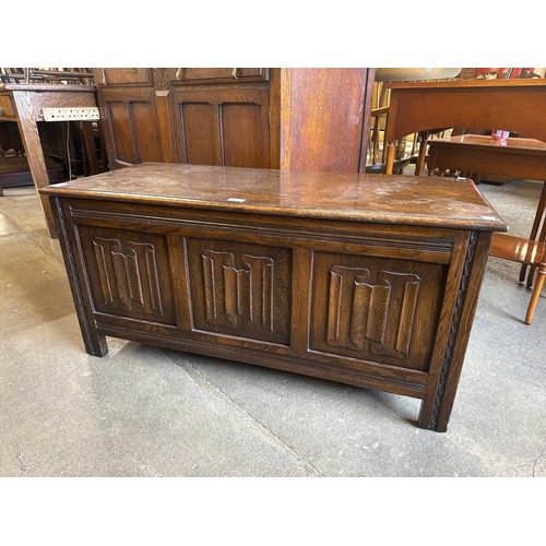 192 - A carved oak linenfold blanket box