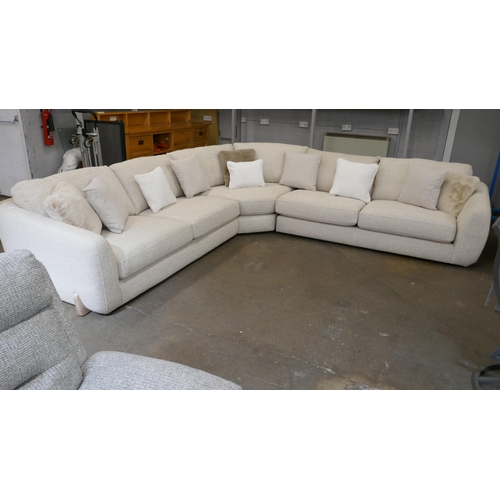 1409 - A large beige corner sofa on semi exposed frame - one odd cushion