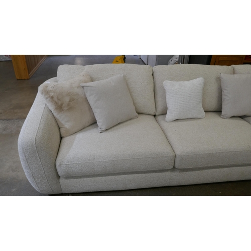 1409 - A large beige corner sofa on semi exposed frame - one odd cushion