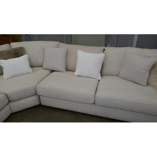 1409 - A large beige corner sofa on semi exposed frame - one odd cushion