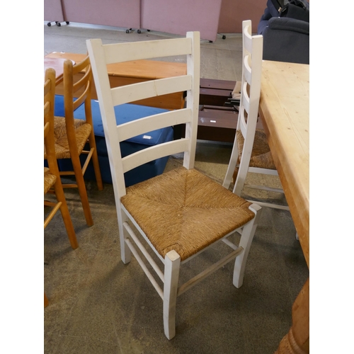 1446 - A pine dining table and four white chairs