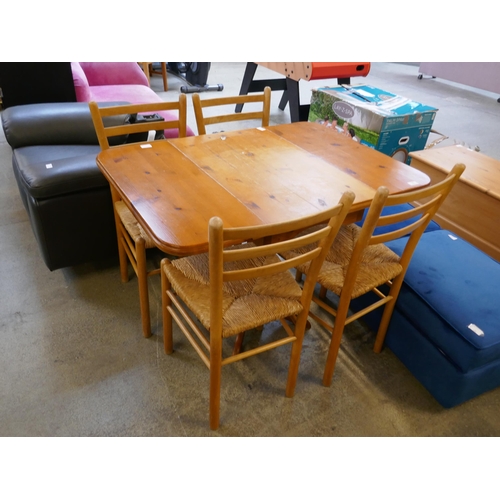 1448 - A pine dining table and four chairs