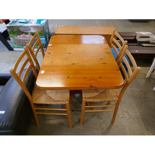 1448 - A pine dining table and four chairs