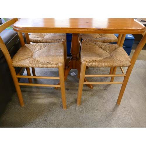 1448 - A pine dining table and four chairs