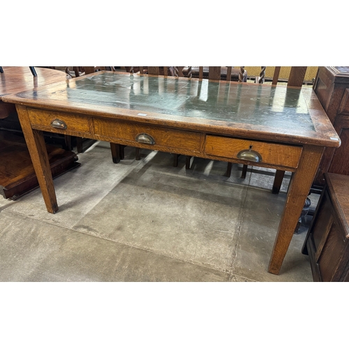 194 - An early 20th Century oak three drawer writing table