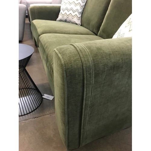 1306 - A moss green velvet three seater sofa and footstool