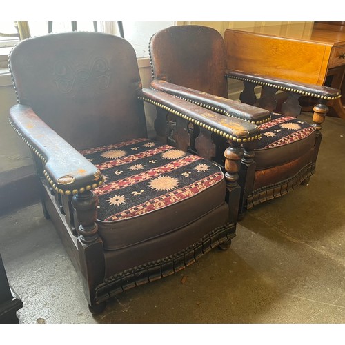 163 - A pair of Art Deco brown leather and brass studded club chairs