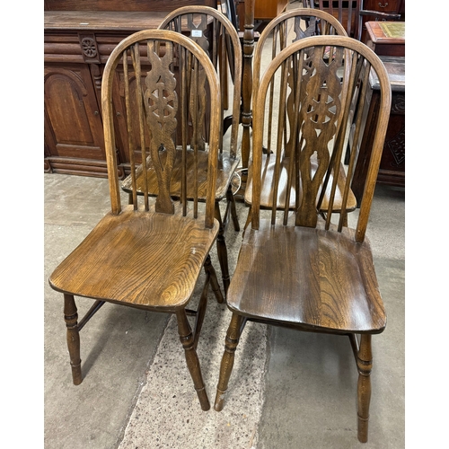 205 - A set of four beech wheelback kitchen chairs