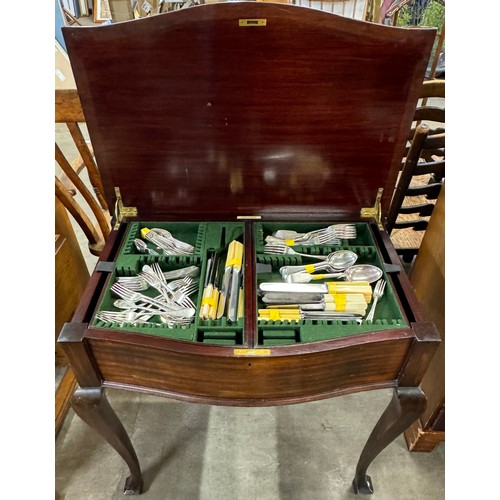 237 - A mahogany canteen of cutlery table, containing faux ivory handled flatware