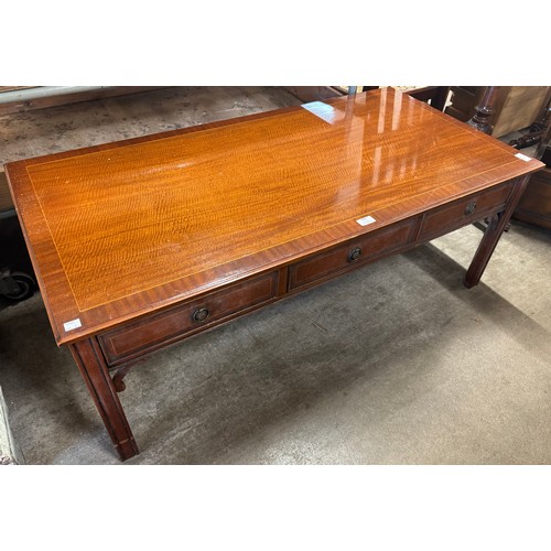 242 - An inlaid mahogany three drawer coffee table