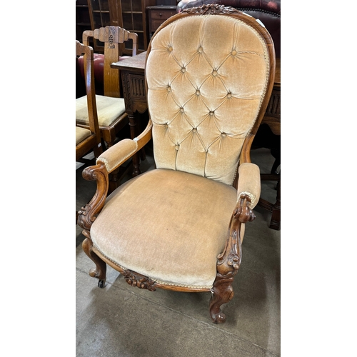 209 - A Victorian carved mahogany upholstered open armchair