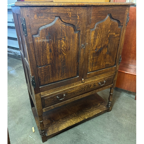 212 - A George III style Ipswich oak cupboard on stand