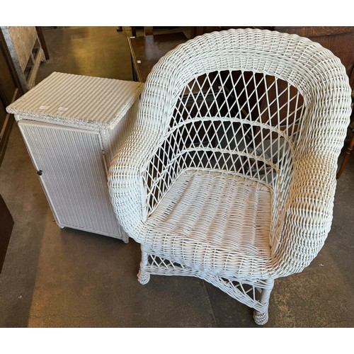 249 - Two wicker armchairs an ottoman