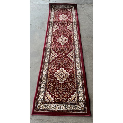 217 - A Turkish red ground runner rug, 230 x 60cms