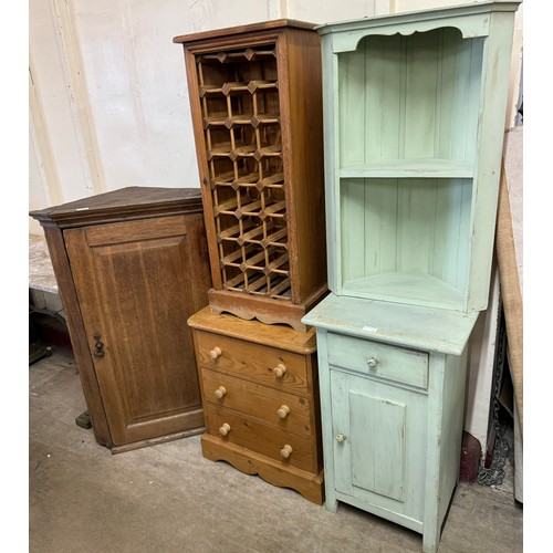 276 - A George III oak corner cupboard, a pine chest of drawers, a pine wine bottle rack, a painted pine w... 