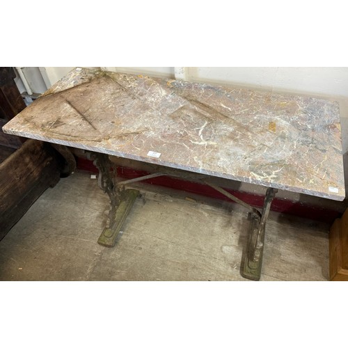 277 - A cast iron based garden table, with marble top