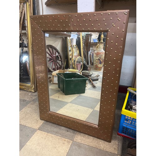 394 - A riveted copper framed mirror