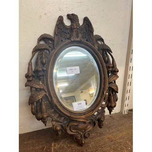 399 - A small Regency style gilt cast iron framed mirror