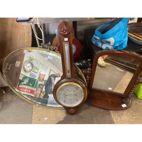 406 - A Victorian mahogany toilet mirror, an oval brass framed mirror and an aneroid barometer