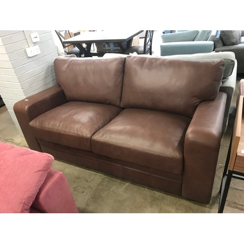 1366 - A Brown leather upholstered three seater sofa  *This lot is subject to VAT