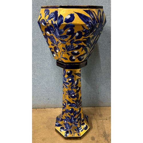 304 - An early 20th Century Staffordshire Phoenix Ware blue and gilt porcelain jardiniere on stand