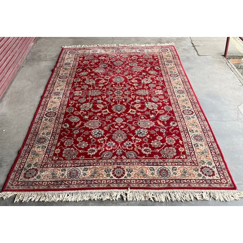 215A - A large red ground rug (312cm x 200cm)