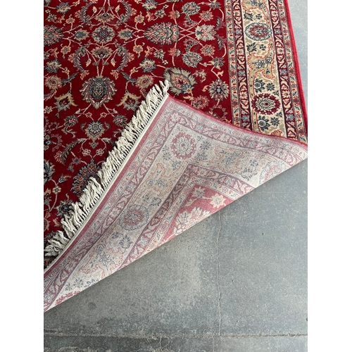 215A - A large red ground rug (312cm x 200cm)