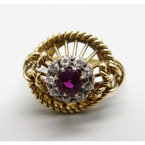 1170 - A yellow metal ring of openwork design, set with a ruby and diamond cluster, tests as 15ct gold, 6g,... 