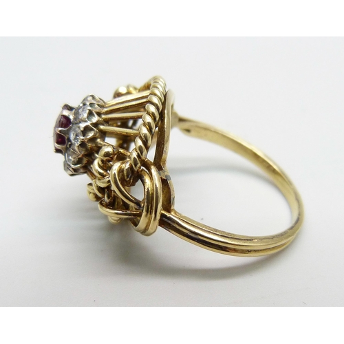 1170 - A yellow metal ring of openwork design, set with a ruby and diamond cluster, tests as 15ct gold, 6g,... 