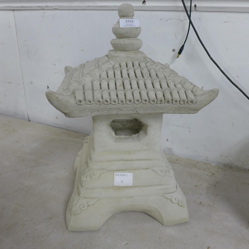 2094 - 2 stone effect concrete Buddha figures and a stone effect concrete oriental style pagoda
