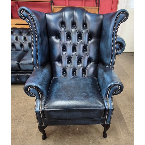 2 - A blue leather Chesterfield wingback armchair